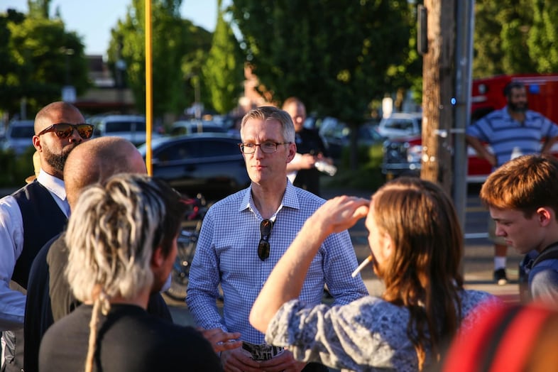 Portland Mayor Ted Wheeler speaks with citizens at the Hollywood vigil.