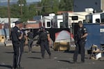 Bend police are shown during the operation to close Emerson Avenue in Bend on June 23, 2021.