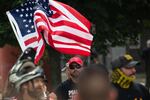 Joey Gibson, leader of Vancouver-based Patriot Prayer, a group that attracts white supremacists and has engaged in violence, waves an American flag at a white supremacist rally in Portland, Ore., Saturday, Aug. 17, 2019. The rally organized by the Proud Boys, labeled a hate group by the Southern Poverty Law Center, attracted militia members, white supremacists and neo-Nazis and carried the potential for violence.