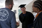 Sam Hannah, center, chats with fellow graduates at the Deer Ridge Correctional Institution in Madras, Ore., on June 9, 2026.