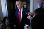 President Trump speaks to members of the press aboard Air Force One on Sunday.