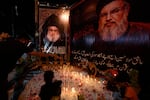 Shiite Muslims light candles during a protest against the killing of Hezbollah leader Hassan Nasrallah, in Karachi, Pakistan on Saturday.