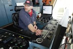 Steven VanHorn sits at the dredge arm control unit on the bridge of the Essayons, Oct. 4, 2023.