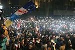 Demonstrators stand in front of police during a rally outside the parliament's building to protest the government's decision to suspend negotiations on joining the European Union for four years in Tbilisi, Georgia, on Saturday, Nov. 30, 2024.