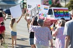 Families, staff and community members marched in support of the LGBTQ+ community and Black Lives Matter ahead of a Newberg, Ore., school board meeting Aug. 10, 2021. The school board voted to ban Black Lives Matter and pride flags.