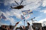 People cheer as an Israeli Air Force CH-53 military transport helicopter carrying newly-released Israeli hostages Omer Shem Tov and Eliya Cohen arrives at Beilinson Hospital in the Rabin Medical Centre in Petah Tikva in central Israel on February 22, 2025.