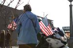 A woman watches the memorial procession for slain Seaside Police Sgt. Jason Goodding.
