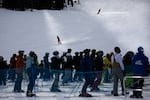 Skiers and snowboarders finish runs at Mt. Bachelor ski resort outside Bend, Ore., Monday, Dec. 7, 2020. Mt. Bachelor opened its winter ski season with new restrictions to limit the spread of coronavirus.