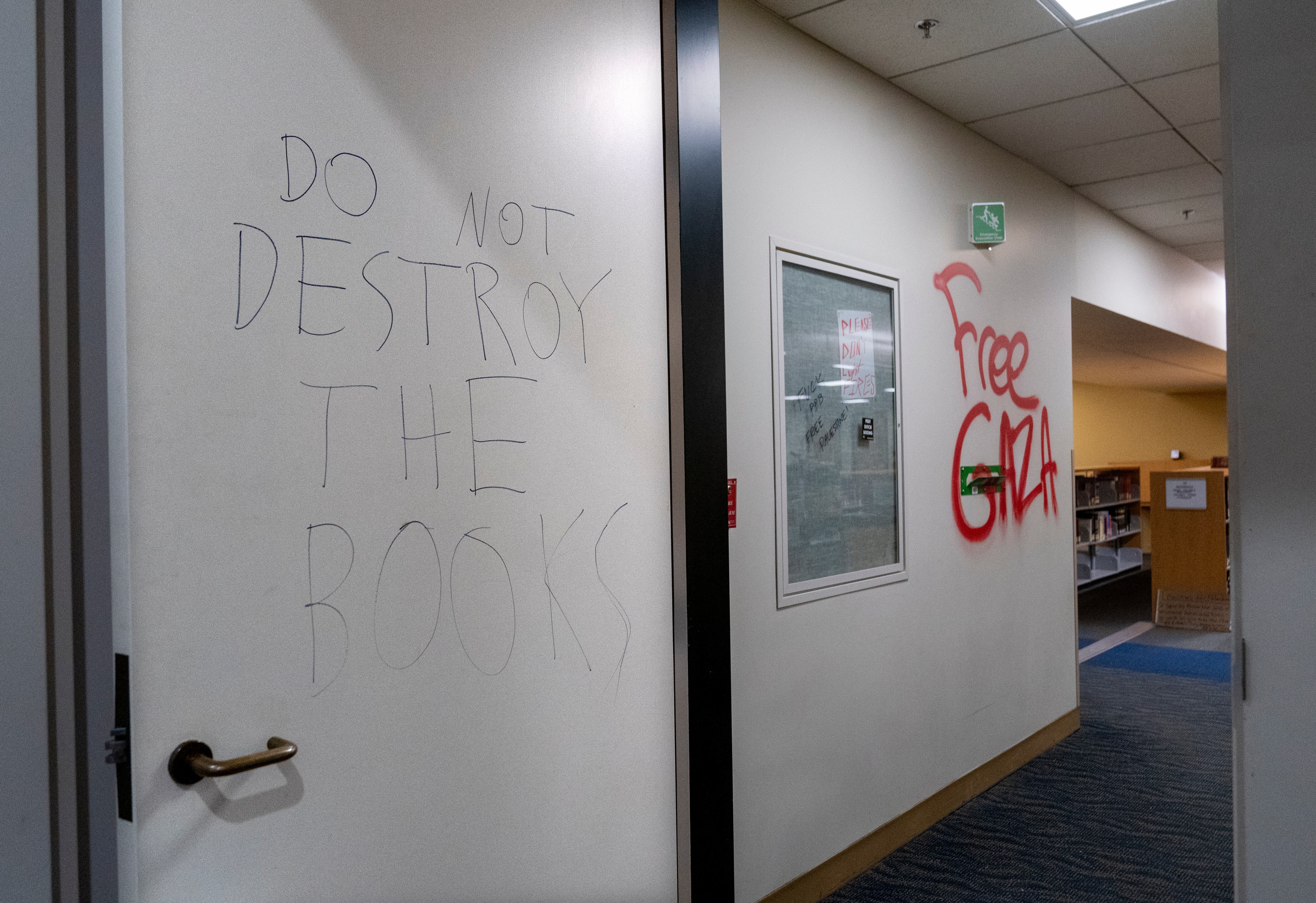 Graffiti asking occupants to protect the archives and book areas.