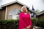 Eileen Quiring stands outside her home, where she has hung a "Thin Blue Line" flag, in late August 2020. As the board chair of the Clark County Council, her views on race and politics have echoed throughout the county.