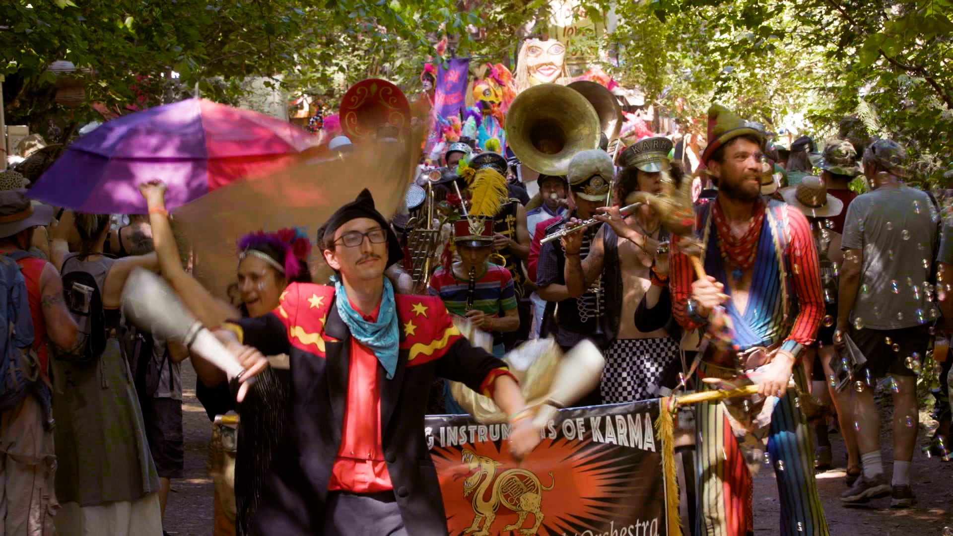 The Fighting Instruments of Karma Marching Chamber Band/Orchestra snake their way down the path at the Oregon Country Fair on July 13, 2024.