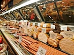 At least two people have died and more than a dozen have been hospitalized in connection with a listeria outbreak linked to meat sold at deli counters, the Centers for Disease Control and Prevention said.