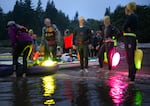 Swimmers and their safety boaters line up to begin the swim at Knappton Cove, Wash., just before dawn on Aug 11, 2024. The swim began at approximately 5:45 am to take advantage of favorable tide conditions. 