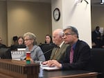 Former Gov. Gary Locke listens as former Gov. Chris Gregoire testifies in favor of I-1000 in April. Sitting between them is former Gov. Dan Evans.