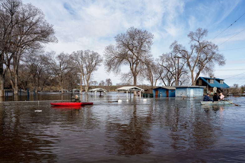 Area residents navigate the flooding near Triangle Park in Burns, Ore., March 30, 2025. 