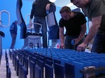 Crew members set up more than 1,000 dominos on the set of United's new safety video.
