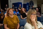Attendees listen closely.