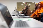 Rugaya Ismail, Center, is reflected on Free Geek on Thursday, May 15th, 2025, in Portland, ORE, during a keyboard course.
