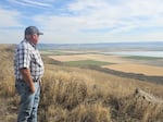 Scott Seus, president of the Klamath Water Users Association, looks over the Tule Lake National Wildlife Refuge from Sheepy Ridge on Aug. 20, 2026. Seus supports a proposal to circulate water through agricultural lands and refuge wetlands before returning it to the Klamath River.
