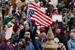 People protest against President Donald Trump and Elon Musk outside the Michigan Capitol in Lansing, Mich., on Feb.5, 2025.