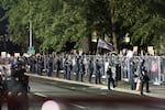 A seventh night of protests ended with police using tear gas, flash bangs and rubber bullets to dispersion the crowd after protesters threw water, fruit, and bottles at police and then knocked down the fence surrounding the building.