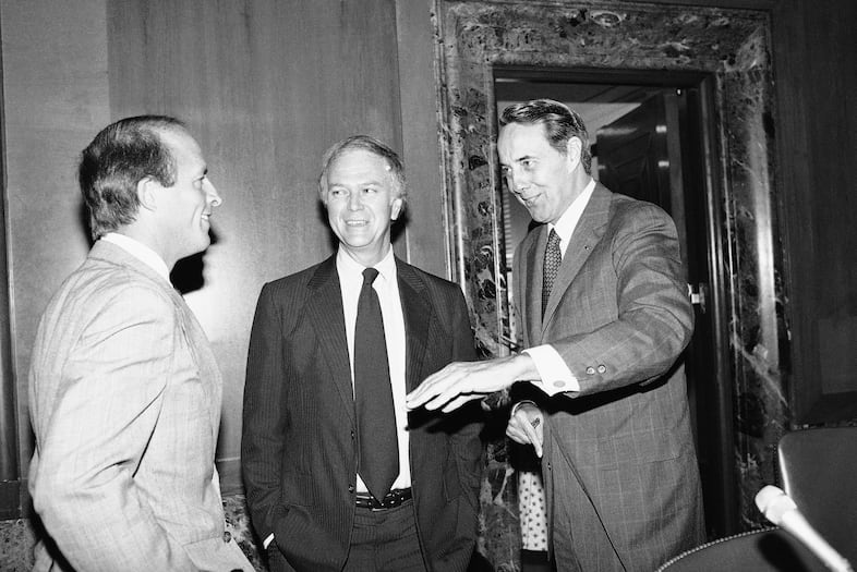 Assistant Treasury Secretary John E. Chapoton, left, chats with Senate Finance Committee Chairman Sen. Robert Dole of Kan., right, and Sen. Bob Packwood, R-Ore., Monday, August 9, 1982 on Capitol Hill, Washington prior to a meeting of the group. Chapoton is a tax policy expert at Treasury.