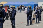 Police conduct a search operation at a makeshift camp of migrants who want to cross the English Channel to Britain near Dunkirk, northern France, Wednesday, May 27, 2026.