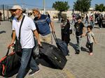 People enter the Rafah border crossing in the southern Gaza Strip before crossing into Egypt on Nov. 1, 2023.