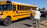 Schoolchildren ride the last bus leaving Silver Rail Elementary School, in Bend, Ore., Oct. 15, 2026. 