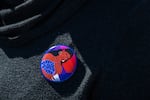 A woman wears a pin that reads "Voting for my Future" at the Gallup Flea Market in Gallup, N.M., on Oct. 12, 2024.