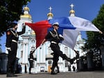 Russian navy recruits perform with the Russian flag in St. Petersburg, Russia, on June 4 during a ceremony marking the departure of recruits to join the army. In a year filled with elections around the world, Russia has stepped up its overt and covert propaganda efforts with a goal of weakening international support for Ukraine and undermining democratic institutions.