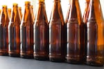 Seven Oregon breweries will be selling beer in reusable bottles with markings on the glass to indicate that they are refillable.