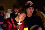 People attending a vigil embrace at LakePoint Community Church in Oxford, Mich., Tuesday, Nov. 30, 2021. Authorities say a 15-year-old sophomore opened fire at Oxford High School, killing several students and wounding multiple other people, including a teacher. (AP Photo/Paul Sancya)