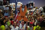 Relatives and supporters of Israeli hostages held in Gaza attend a rally in Tel Aviv on Saturday demanding the hostages' release from Hamas captivity and calling for an end to the war.