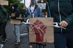A protester walks their adorned bike during a march against racist violence and police brutality on June 8, 2020. Demonstrations are now entering their third week in Portland.