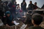 Palestinians displaced by the Israeli bombardment wait for their turn to bake bread at the makeshift tent camp in the Muwasi area in Rafah, Gaza Strip, Saturday, Dec. 23.