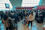 Passengers queue at a flight connection desk at the Dubai International Airport on Wednesday. Dubai's main airport diverted scores of incoming flights on Tuesday as heavy rains lashed the United Arab Emirates, causing widespread flooding around the country.