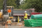 FILE - Three workers digging out space for the new housing development on 74th and Glisan Street on July 7, 2023. 