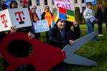 FILE - Emma LeFever, with Washington CAN, smiles before a group photo following a rally against tax cuts for corporations on Thursday, February 26, 2026, at the Washington State Capitol campus in Olympia.