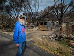 Joseph Powell stands among his neighbors’ destroyed homes at Talent Mobile Estates in Talent, Ore. on October 13, 2020. Powell’s home is one of a few there that the Almeda Fire left standing.