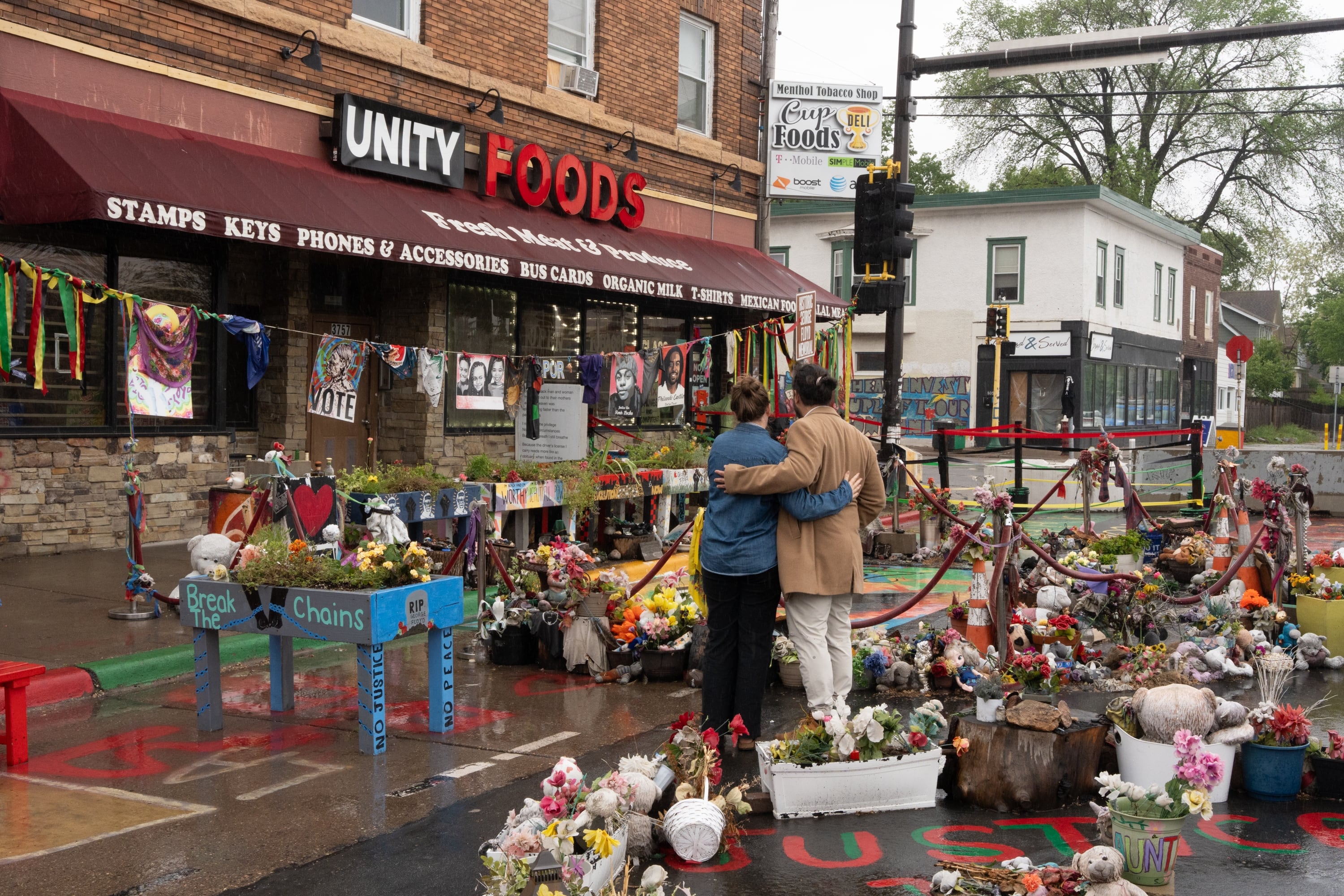Visitors Taylor Walters and Gerardo Rodriguez Orellana embrace as they take in the memorial space at George Floyd Square, Wed., May 21, 2025, in Minneapolis, Minn.