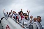 Activists from the Global Sumud Flotilla disembark a plane upon arriving at Istanbul Airport, in Istanbul, Turkey, Thursday, May 21, 2026.