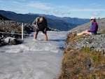 Oliver Grah and Liza Kimberly measure the flow of glacier-fed Sholes Creek on Mount Baker