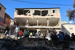People gather in front of a damaged building following a raid by Israeli troops on the Palestinian Nur Shams camp in the occupied West Bank.