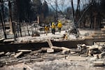 Firefighters from both Moses Lake, Washington, and Santa Fe, New Mexico, spot-check a neighborhood that burned to the ground on Wednesday, August 5, 2026, in northwest Spokane. “This is by far and large the worst one we’ve been on, like, hands down,” said firefighter Steve Moyer.