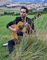 In this undated, provided photo, classical guitarist and composer Tye Austin poses for a portrait in Ashland. Austin kicked off an inaugural concert tour on Aug. 1, 2026 of more than 30 performances at 15 Oregon state parks and other outdoor locations across the state. He hopes to expand the outdoor concerts in coming years by including other musicians and venues outside of Oregon.