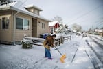 Carolyn McMahon shovels her driveway in Southeast Portland, Wednesday, Feb. 21, 2018.