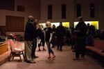 Haley Adams, a Patriot Prayer supporter, rushes the stage during a community listening session at Maranatha Church in Portland, Ore., Thursday, Feb. 21, 2019. City leaders called the meeting to hear community concerns over a police lieutenant's text messages with Patriot Prayer leader Joey Gibson.