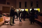 Haley Adams, a Patriot Prayer supporter, rushes the stage during a community listening session at Maranatha Church in Portland, Ore., Thursday, Feb. 21, 2019. City leaders called the meeting to hear community concerns over a police lieutenant's text messages with Patriot Prayer leader Joey Gibson.