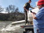 Arron "Troy" Hockaday documents the release of coho while Jeff Campbell, Fish Hatchery Manager at CDFW, makes sure all the fish make it out of the truck.